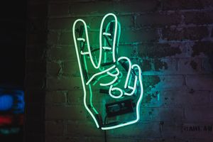 Family and home care symbol with neon glow